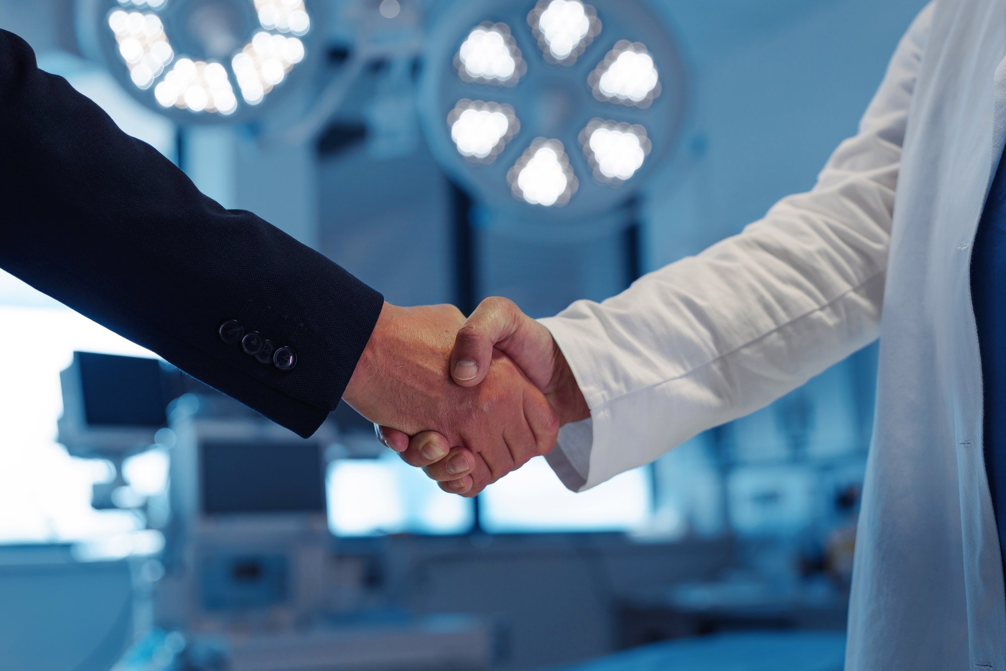 Hospital business handshake in a medical environment