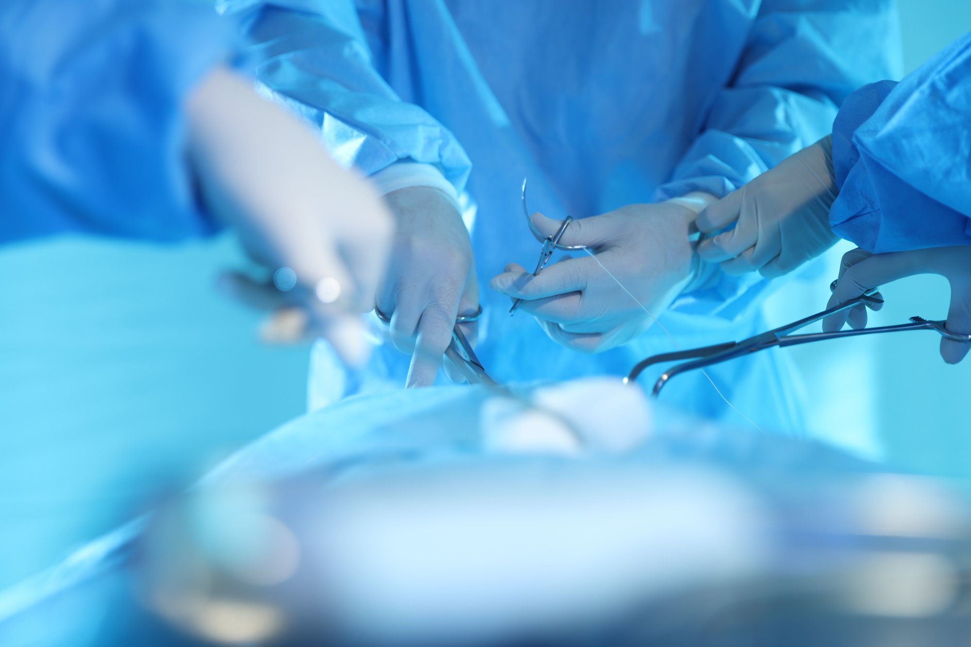 professional surgeons with medical tools
